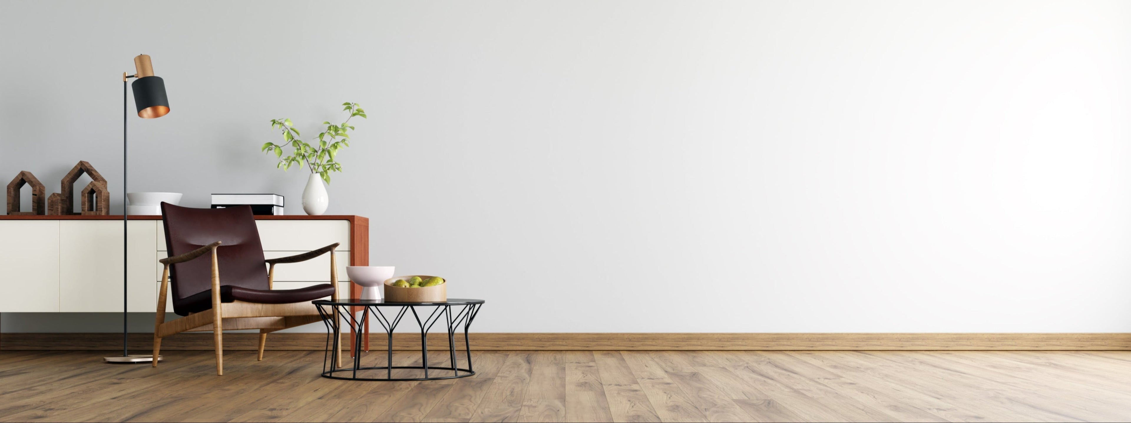 Modern interior with a chair, table, and decorative items against a white wall.
