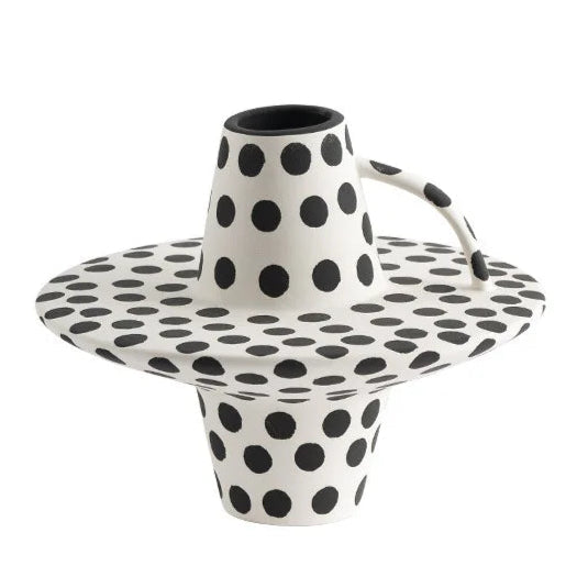 Black and white polka dot ceramic vase and tray on a white background
