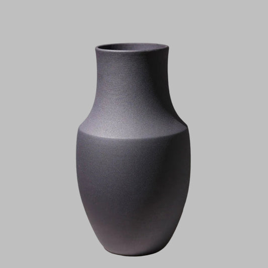 Dark gray textured vase on a light gray background