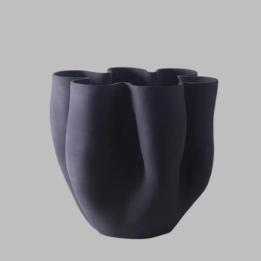 Black ceramic vase with unique design on a white background