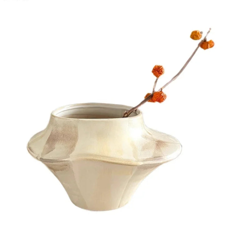 Beige ceramic vase with a branch on a white background, featuring the brand 'ZIZI Fish'.
