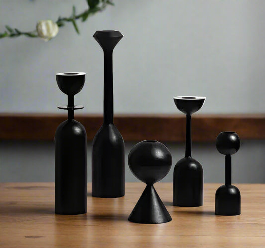 Set of black geometric vases on a white background