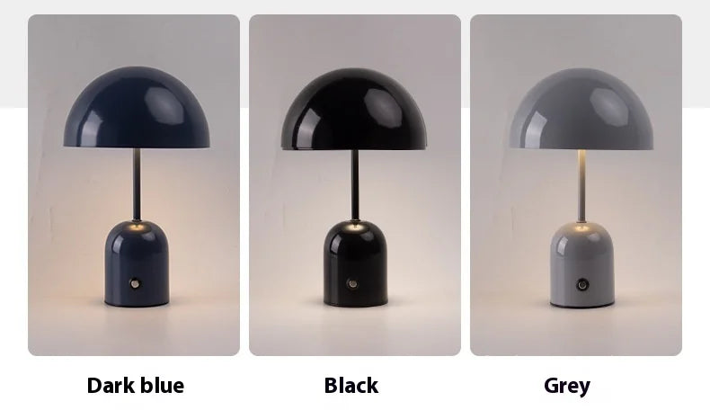 Three table lamps in dark blue, black, and grey on a light gray background.