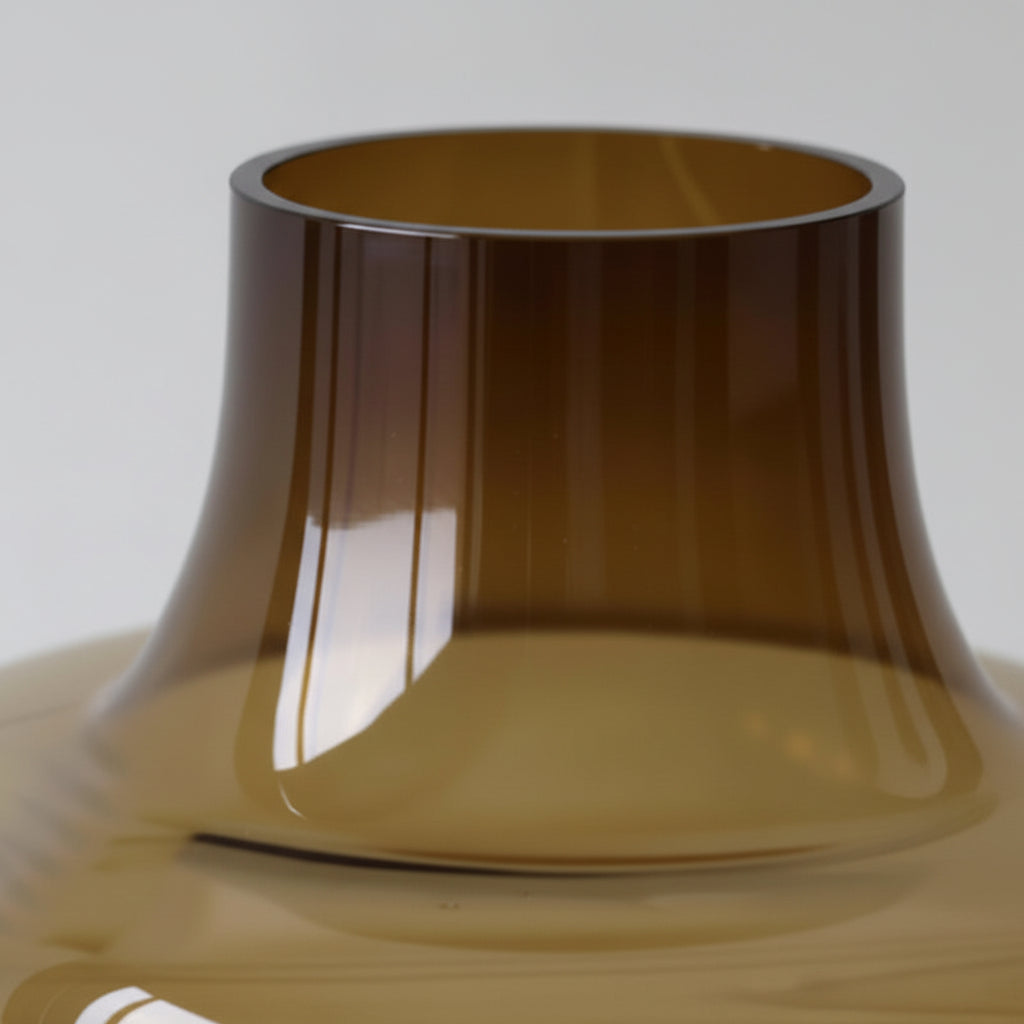 Close-up of a brown glass vase with a plain background