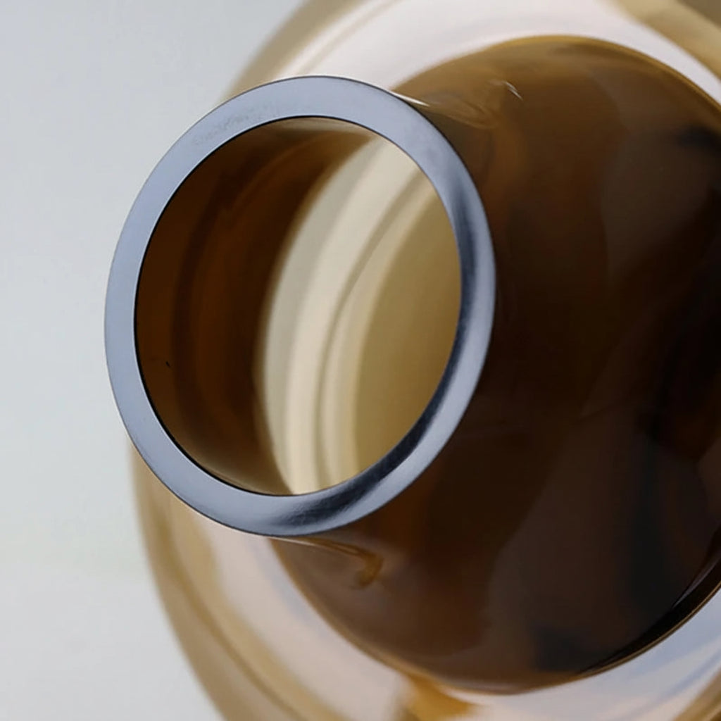 Close-up of a metallic ring with a reflective surface on a light background
