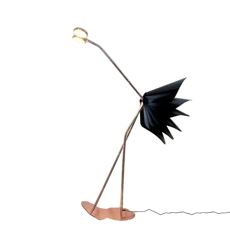 Modern floor lamp with black leaf-like shade in a room setting.