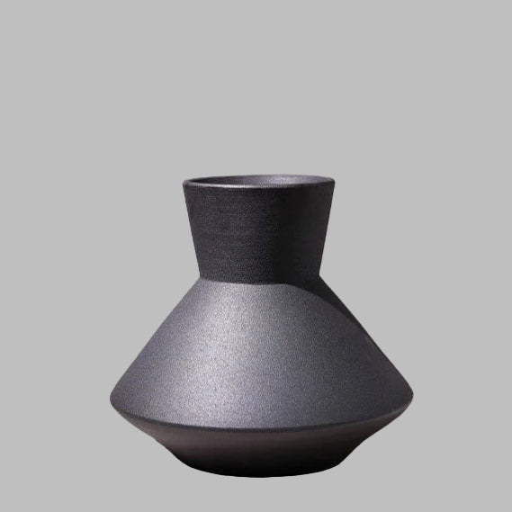 Black textured vase on a light gray background