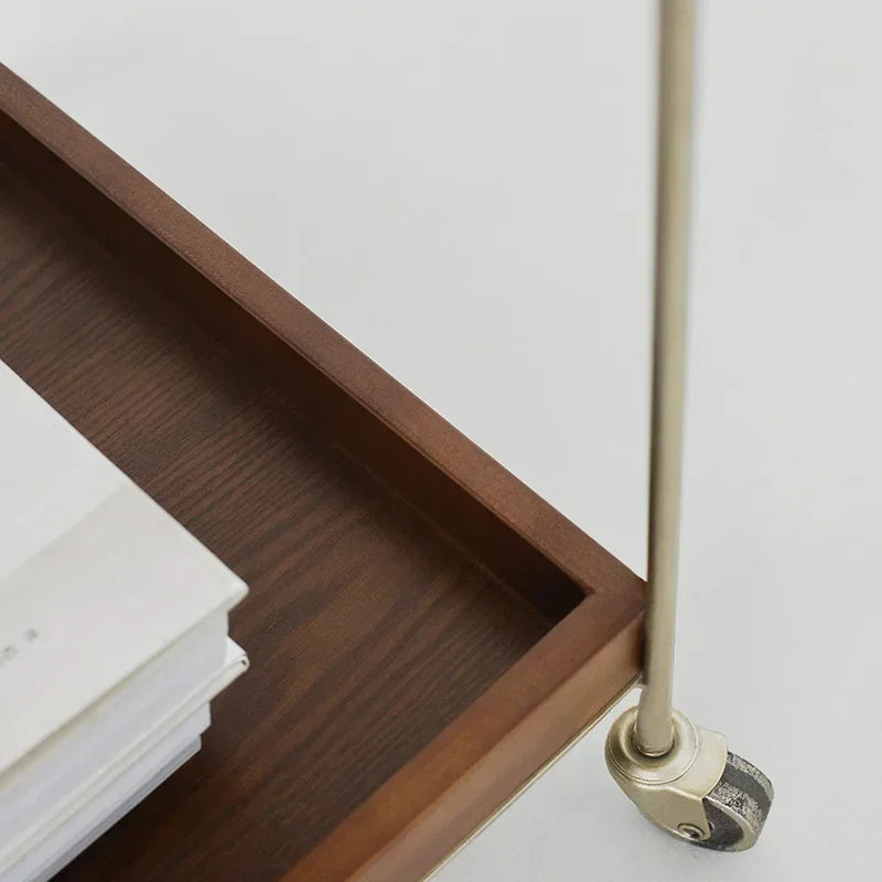 Close-up of Mabel rolling wood cart showcasing warm wood shelves and metal framing.