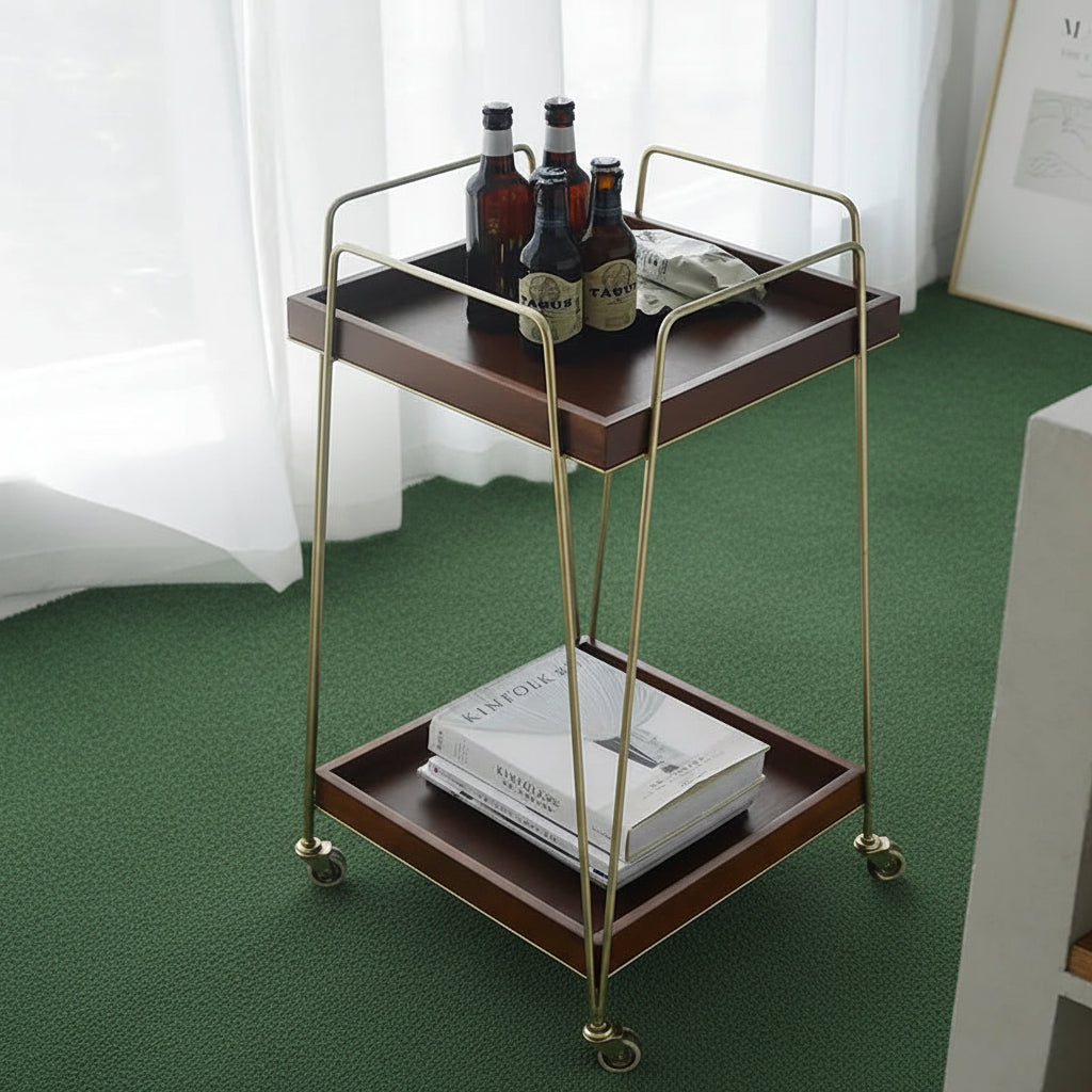 Mabel rolling wood cart showcasing warm wood shelves and elegant brass framing, perfect for versatile home decor.