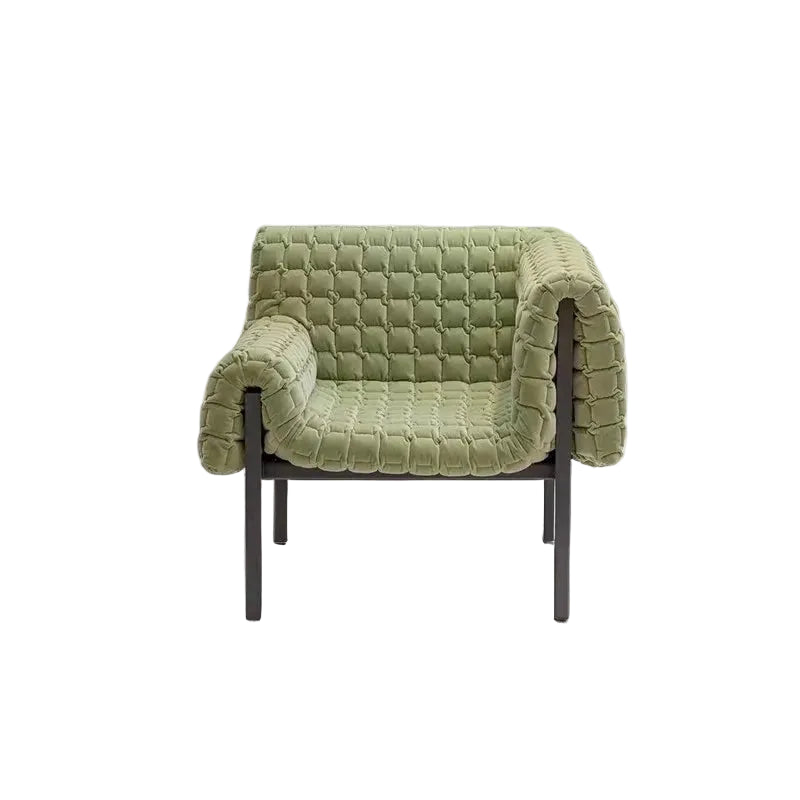 Green quilted armchair on a white background