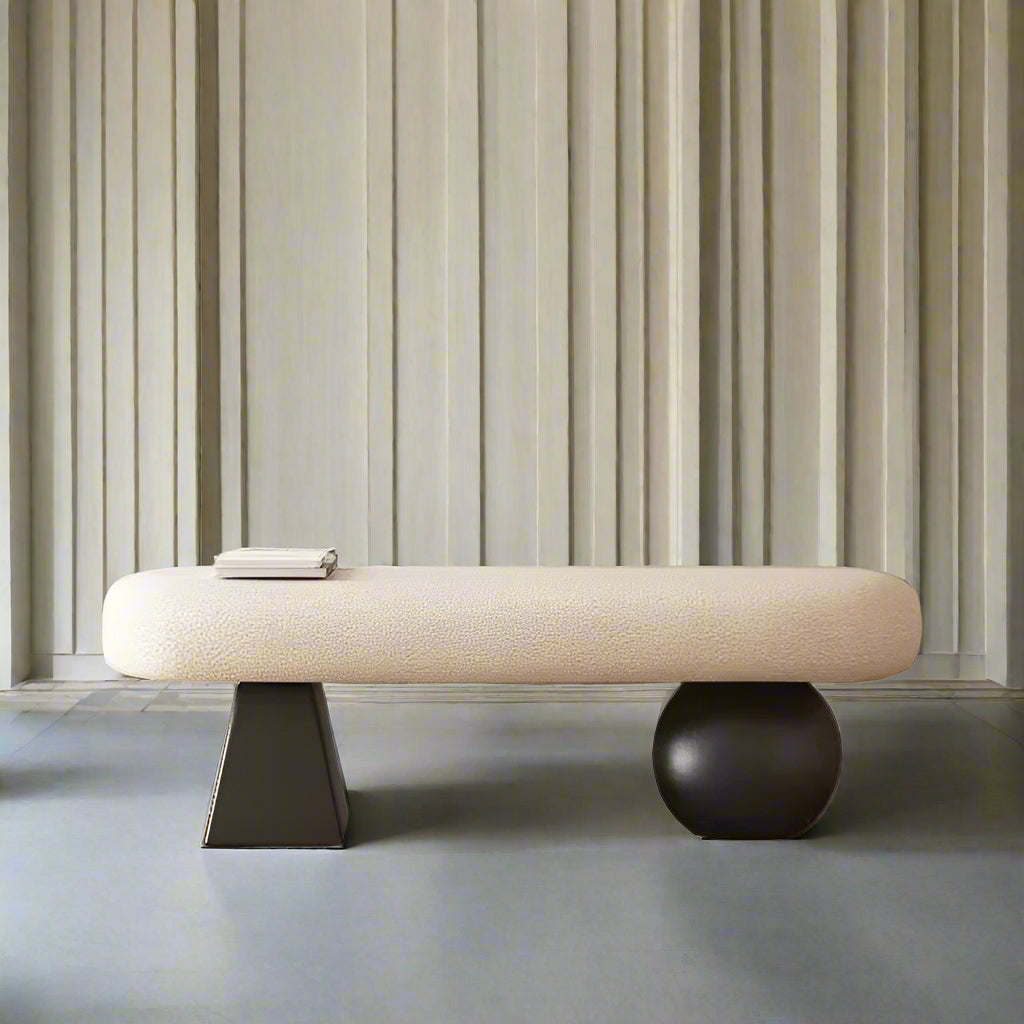Modern bench with a textured surface and black base against a wall with framed art.