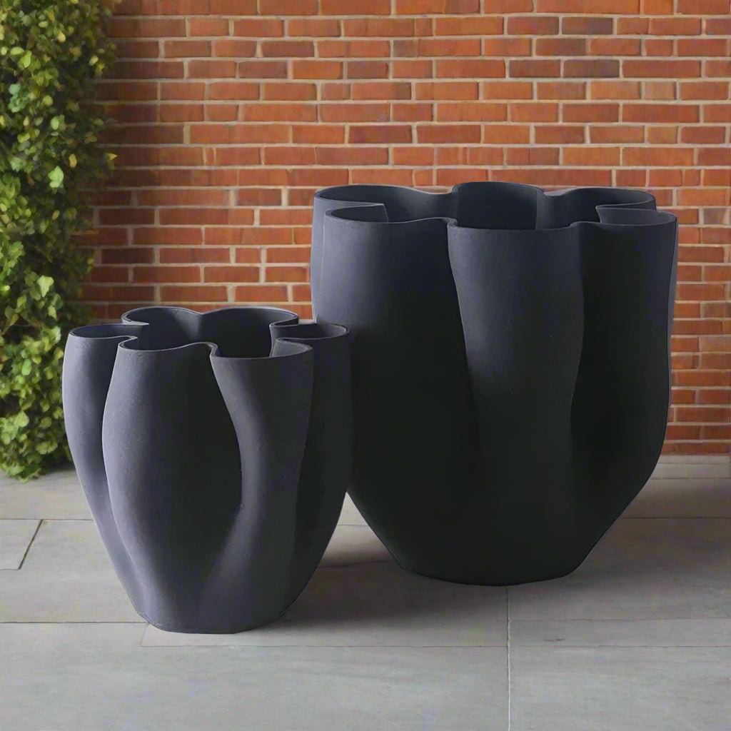 Two black ceramic flower pots with a wavy design on a white background, branded 'ZIZI Fish'.
