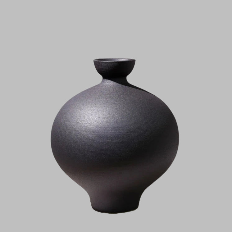 Black ceramic vase on a gray background