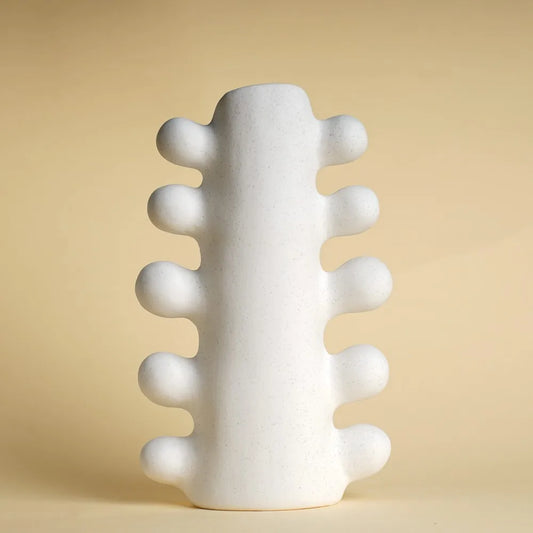 White textured vase on a beige background