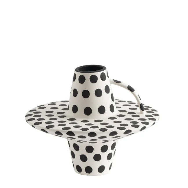 Black and white polka dot ceramic vase and tray on a white background