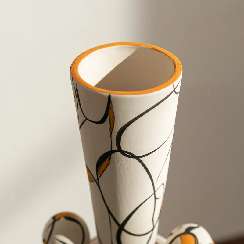 Cylindrical vase with abstract design on a plain background