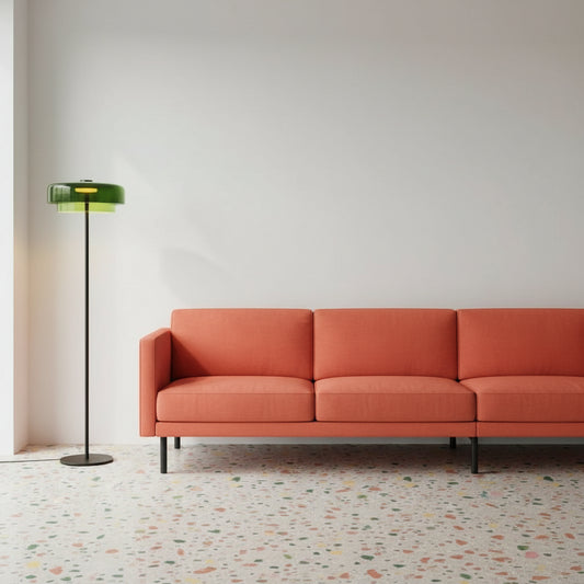 Modern interior with a green floor lamp, white chair, and wooden cabinet.