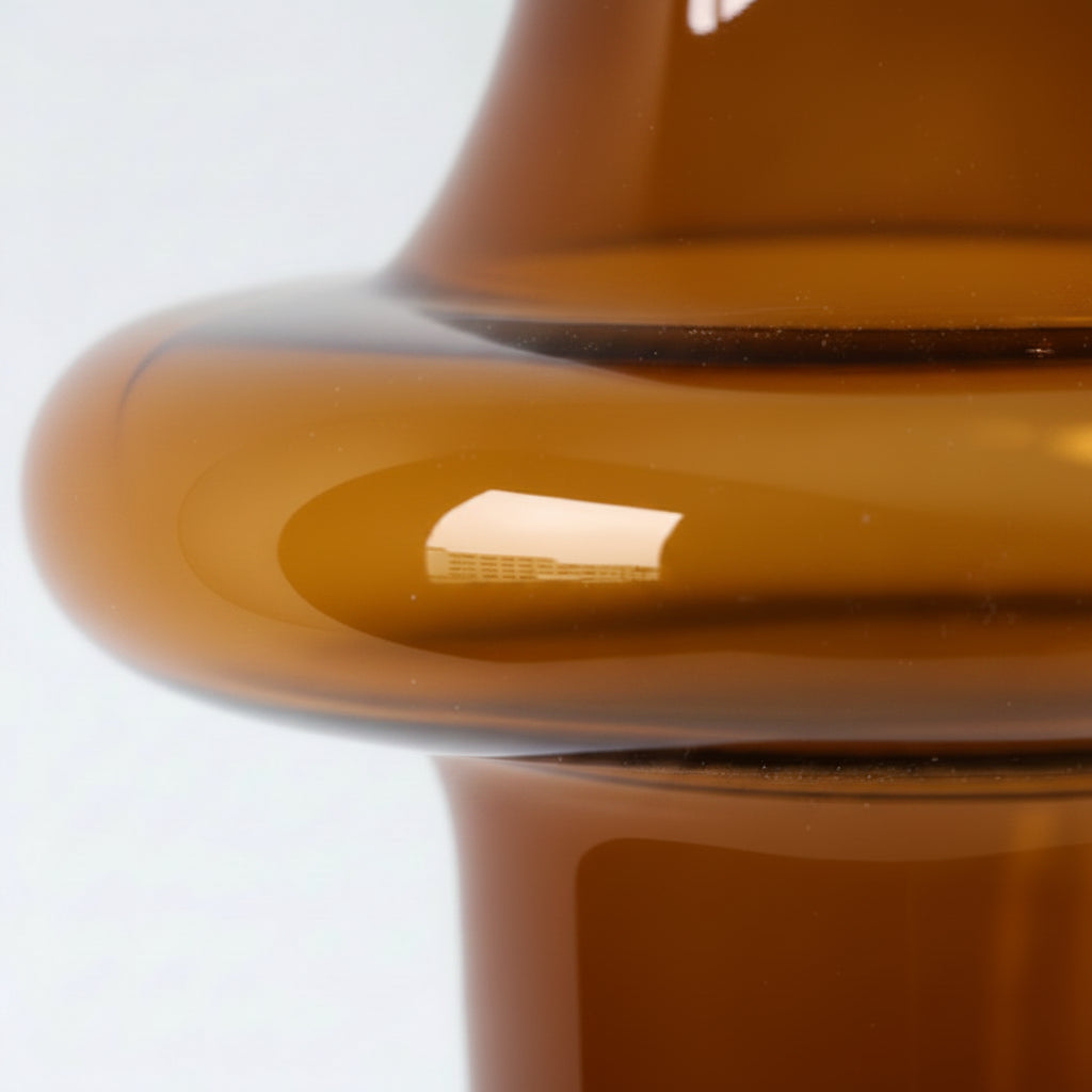 Close-up of a beige ceramic vase with a glossy finish on a white background