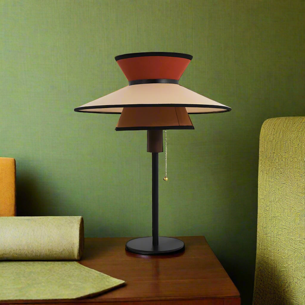 Decorative lamp with layered cone-shaped shades on a white background