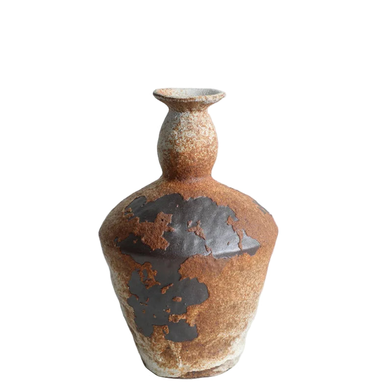 Ceramic vase with brown and black glaze on a light gray background