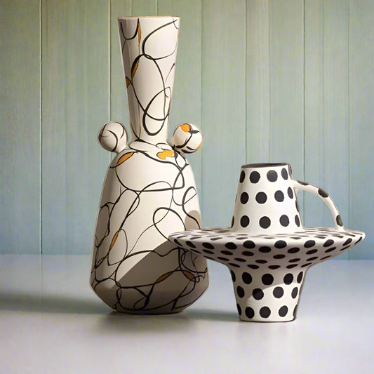 Two ceramic vases with abstract designs on a white background